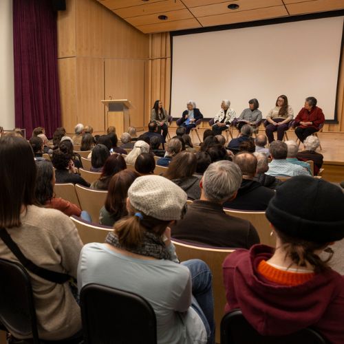 Seated panelists and audience at the Day of Remembrance Discussion Panel